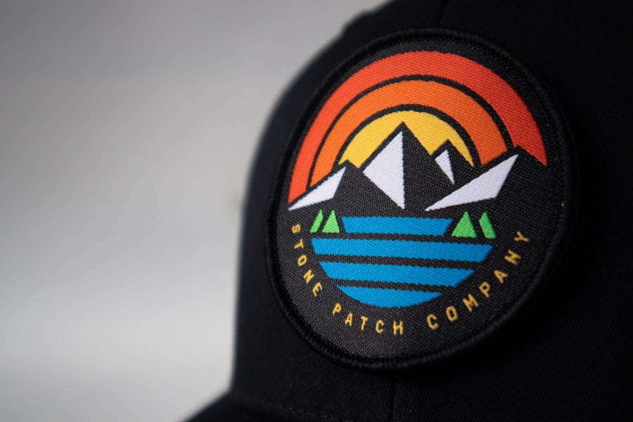 Fitted cap with a black, orange and blue embroidered front design