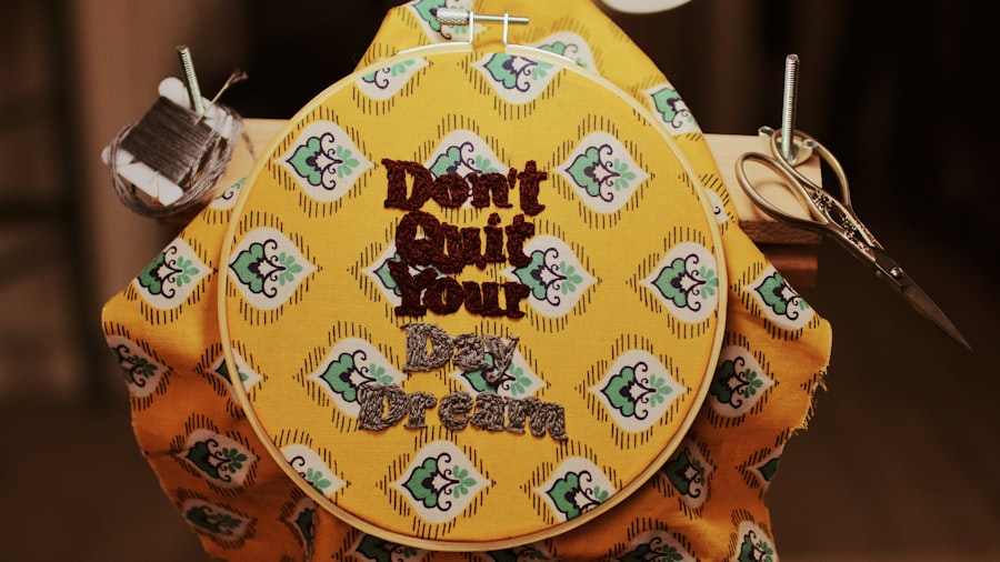 Hand-embroidered pad with yellow and green floral stitching