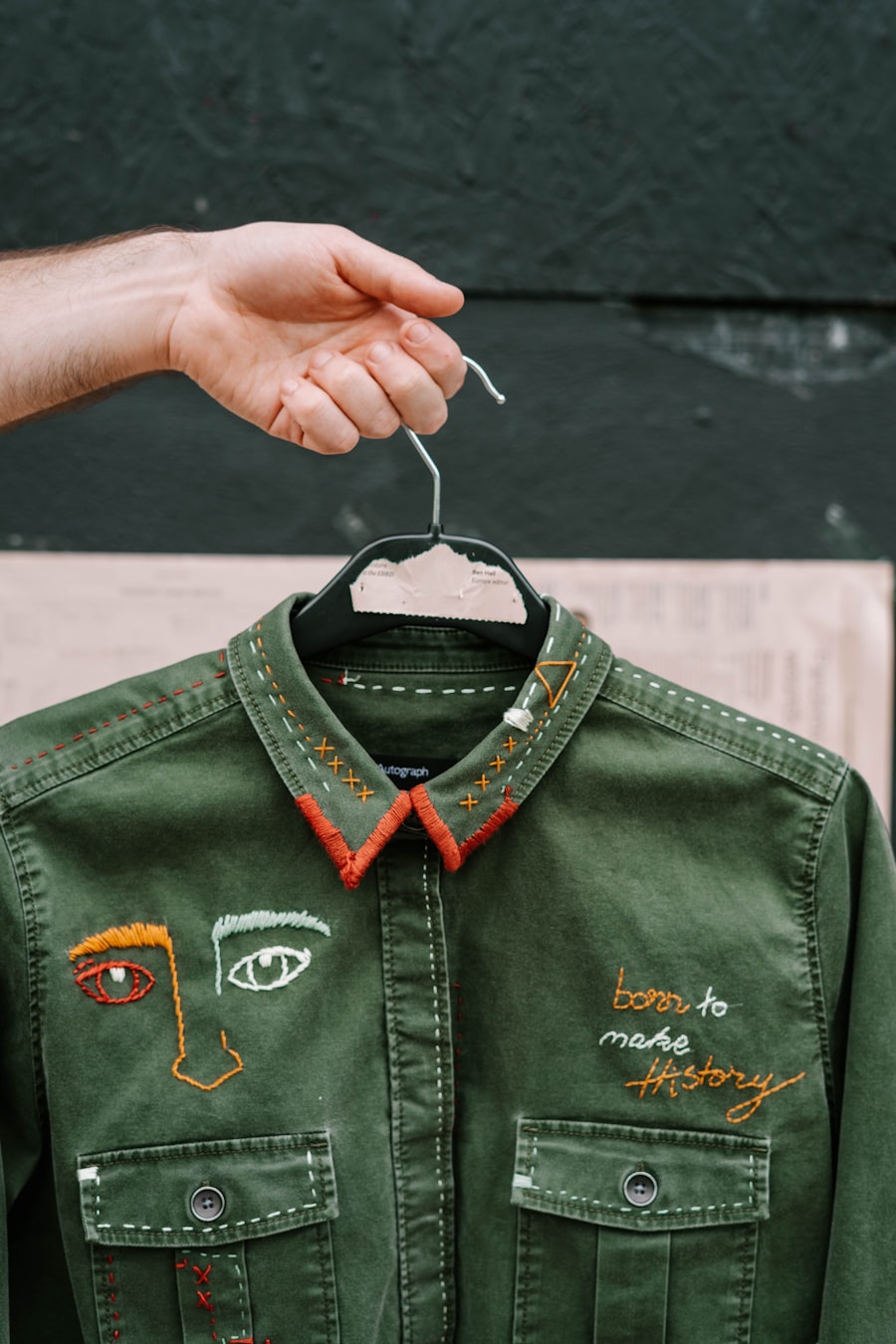 Black leather jacket held up — a blank canvas for an embroidered back patch