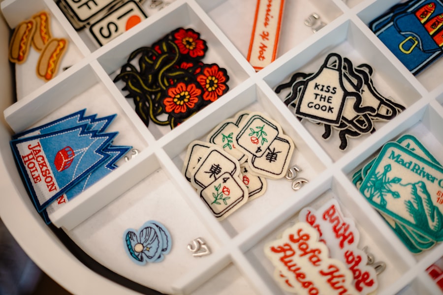 Dozens of embroidered patches sorted in white organizer trays