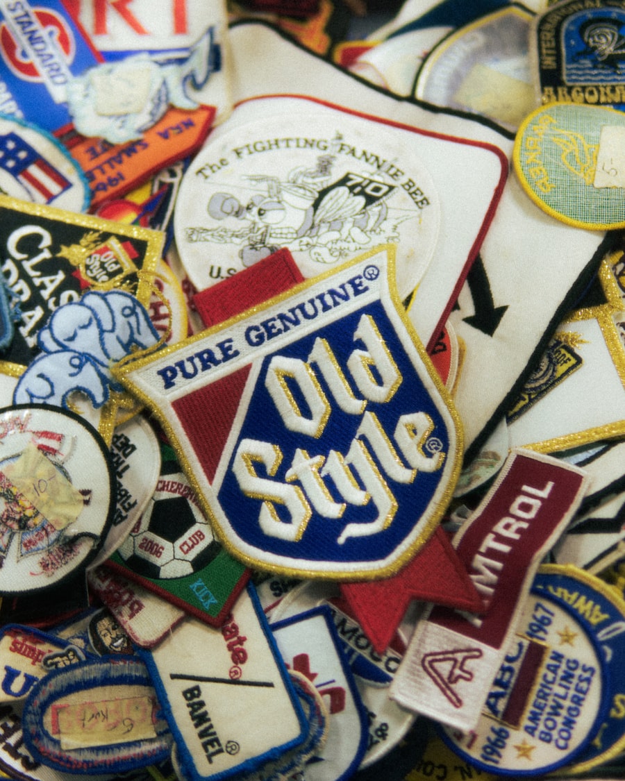 Heap of vintage embroidered patches — shields and badges