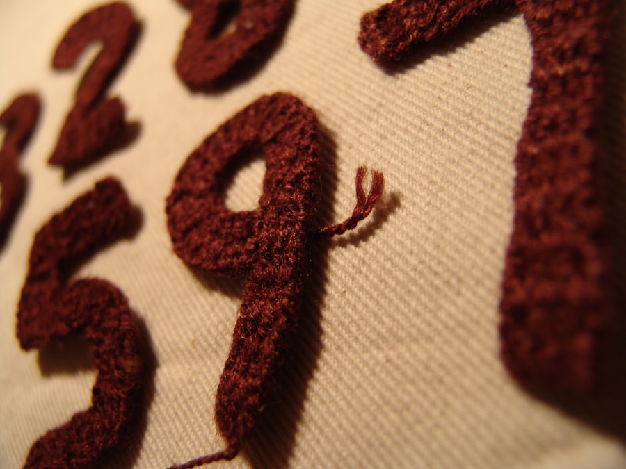 White and red embroidered lettering reading love on textile