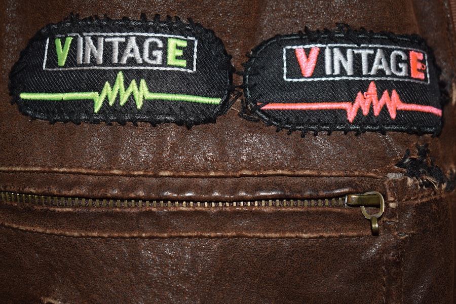 Two vintage embroidered patches sewn onto a brown leather jacket