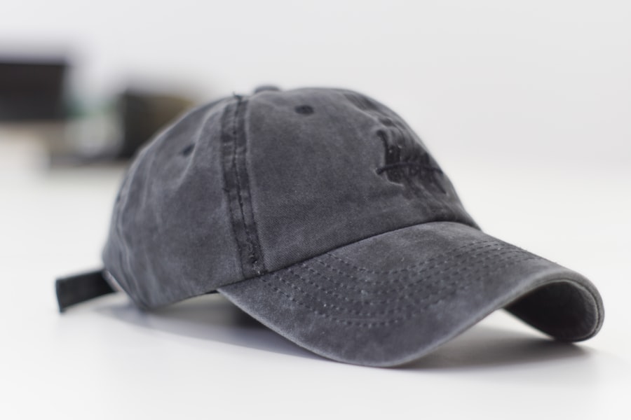 Gray baseball cap on a white surface with embroidered front design
